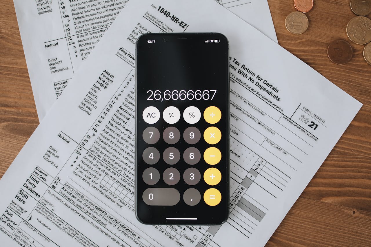 Mobile calculator app on tax documents, highlighting financial calculations and tax preparation.